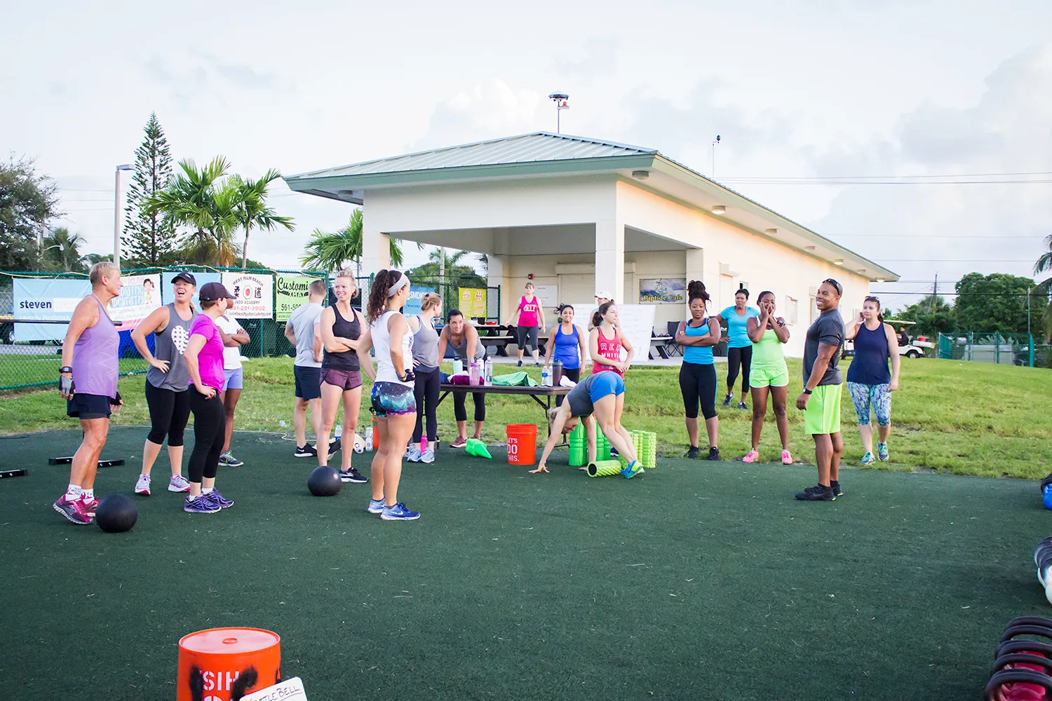 A BEAST Fitness class gathered on the turf between sets, medicine balls and foam rollers at their feet.